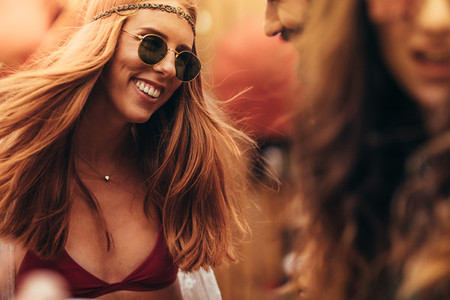Hippie girl with friends at music festival