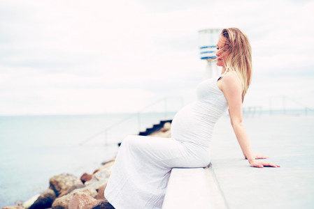 Pregnant young woman relaxing at the seaside
