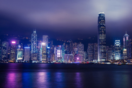 Hong Kong skyline on Victoria Harbour with moody mist and clouds