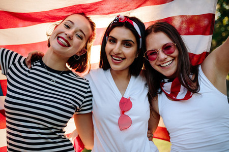 Friends smiling with American flag