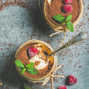 Homemade Tiramisu in glasses with berries and mint leaves
