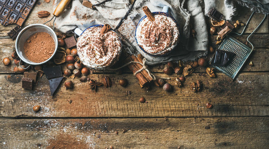 Hot chocolate with whipped cream nuts spices and cocoa powder