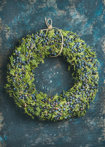 Christmas decorative wreath over dark blue plywood wall background