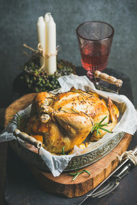 Christmas table set with oven roasted whole chicken and wine