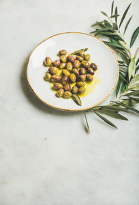 Pickled green Mediterranean olives in virgin olive oil  copy space