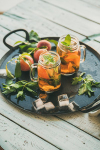 Summer refreshing cold peach ice tea on tray  copy space
