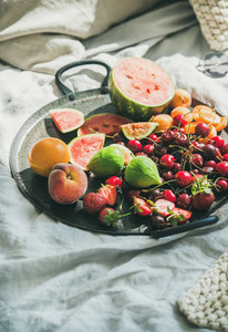 Tray full of fruit over light blanket background  copy space