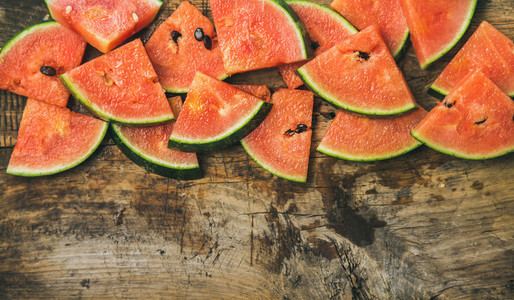 Juicy watermelon pieces over rustic wooden background