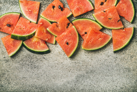 Juicy watermelon pieces over concrete stone background