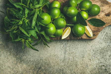 Fresh limes and mint on board for making summer drinks
