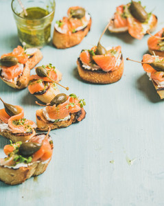 Crostini with smocked salmon  pesto sauce  watercress and capers