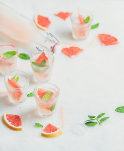 Cold refreshing alcohol cocktail with fresh grapefruit marble background
