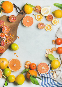 Natural fresh citrus fruits over grey marble table background