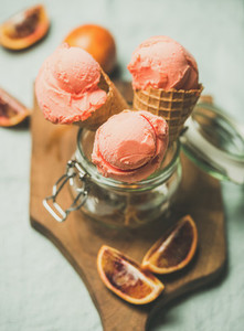 Refreshing summer blood orange ice cream on wooden board