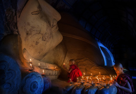 Mini Monk in meditation inside temple