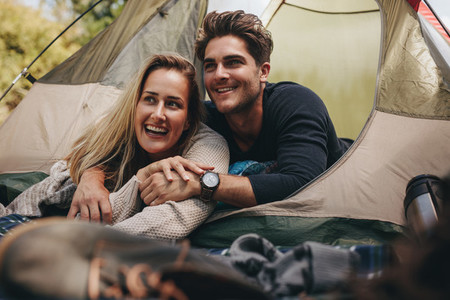 Loving couple relaxing in tent