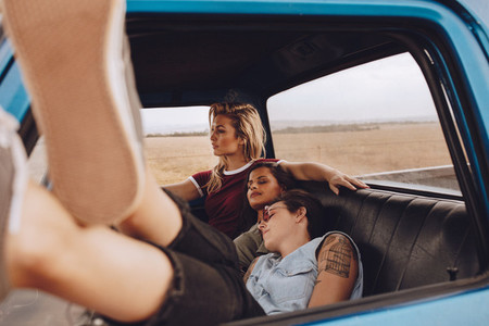 Woman driving car with friends resting