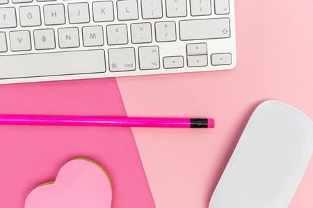Computer keyboard on pink background minimal workspace concept