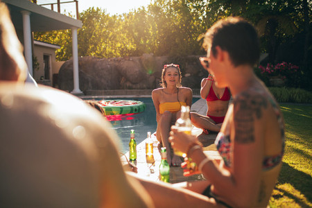 Multiracial friends enjoying at poolside party