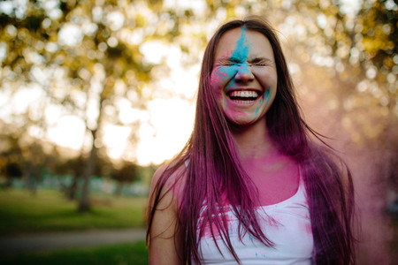 Smiling woman smeared in colors