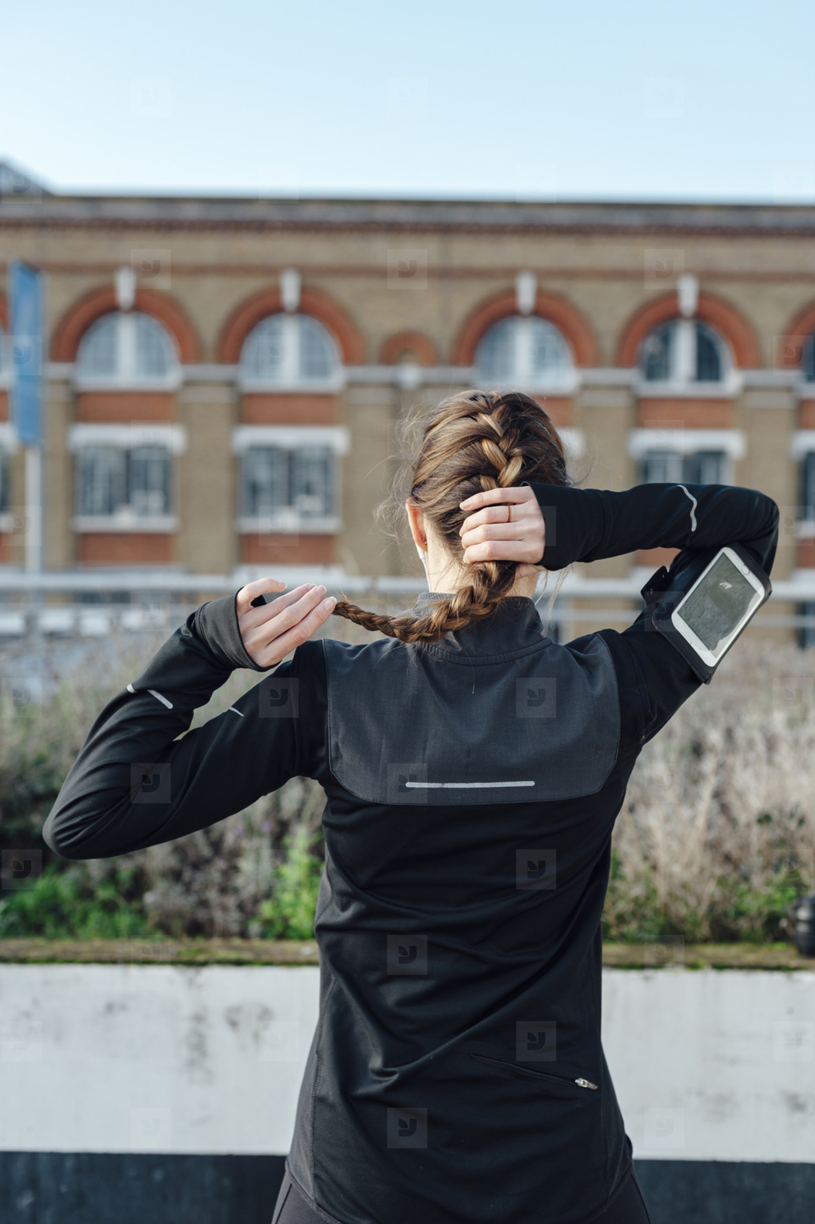 Photos Back View Of A Running Woman Tying Up Her Ponytail Before