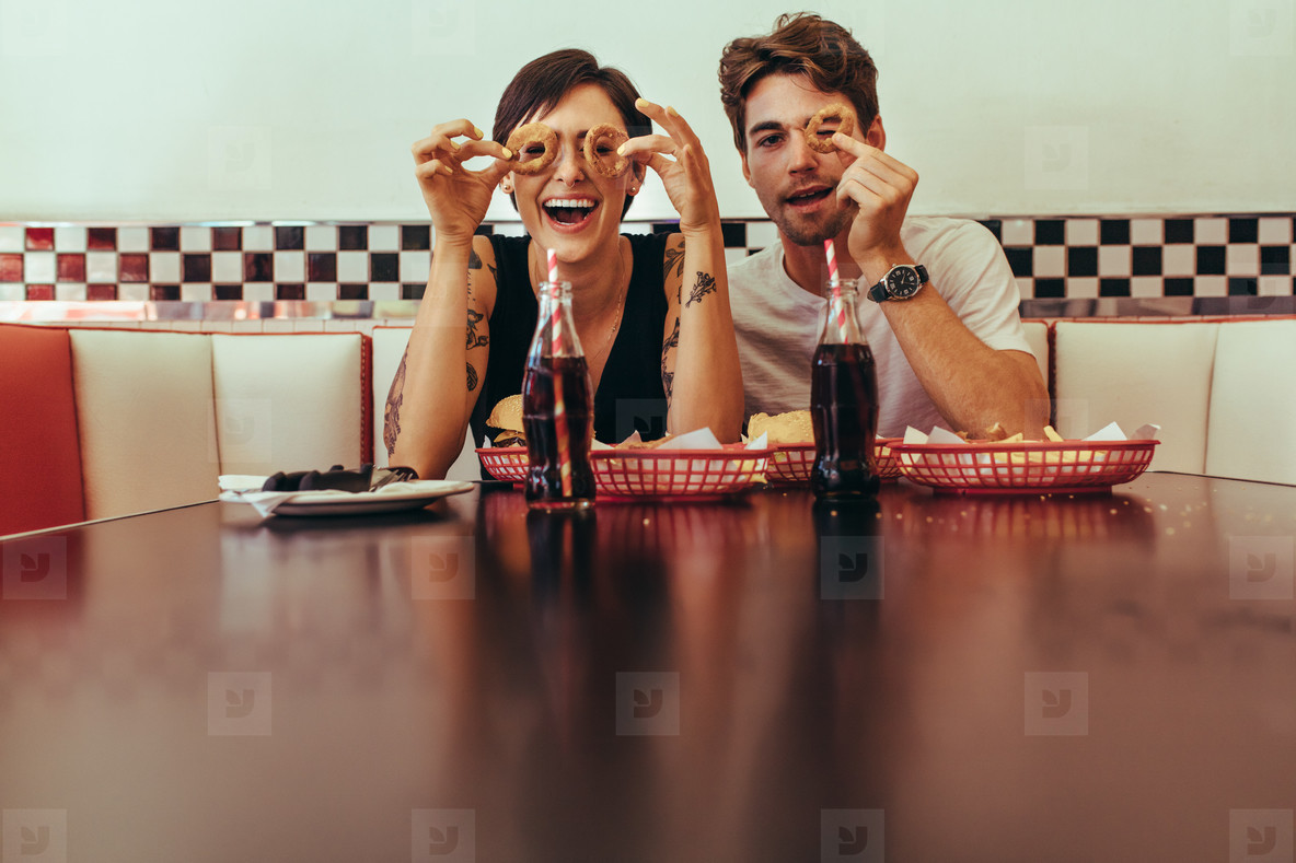 Couple at a restaurant having fun while eating food