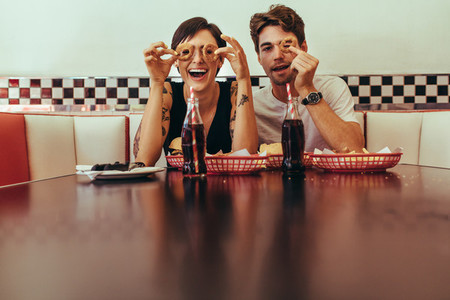 Couple at a restaurant having fun while eating food