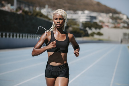 Woman sprinter training on track