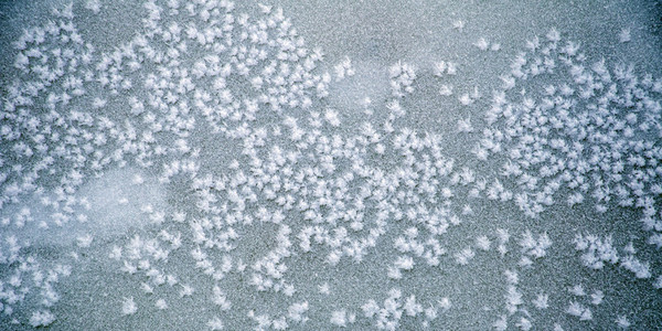 Pattern of snowflakes on ice