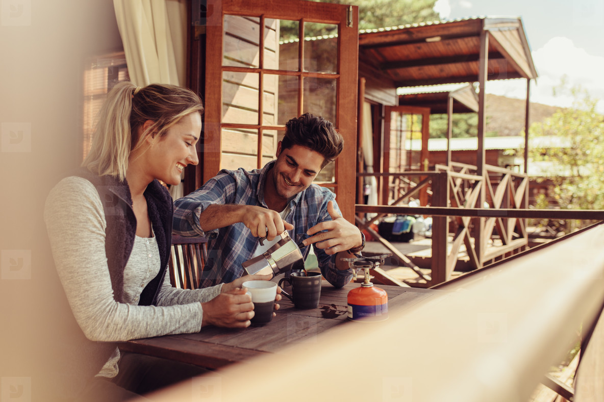 Couple on holiday having coffee in morning