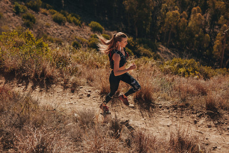 Woman trail runner training for cross country run