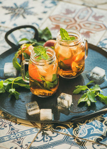 Summer refreshing cold peach ice tea with fresh mint