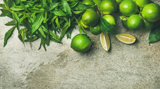 Flatlay of fresh limes and mint for making cocktail