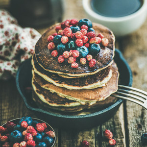 Breakfast with pancakes with forest berries and honey  square crop