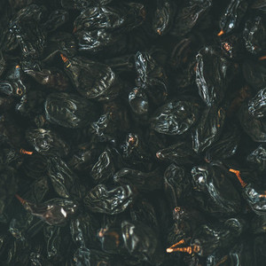 Flat lay of black dried raisins  top view  square crop
