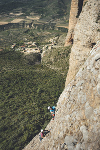Young couple of climbers sharing a rockclimbing route in Los Mallos de Riglos Spain
