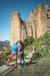 Couple of climbers looking to a climbing route in Los Mallos de Riglos Spain