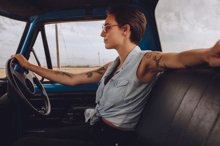 Attractive woman driving an old truck