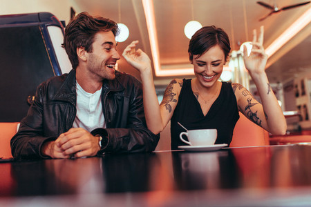 Couple enjoying their time over a coffee at a diner