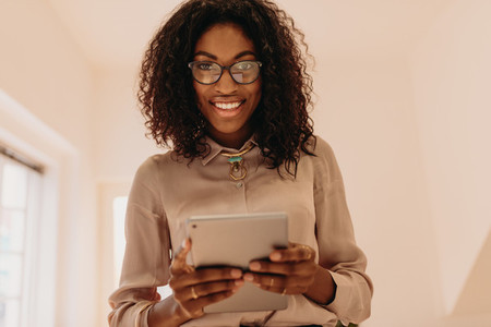 Businesswoman standing holding a tablet pc