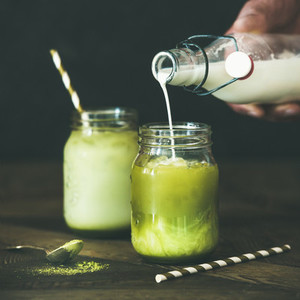 Cold refreshing summer iced coconut matcha latte drink  square crop