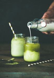 Cold refreshing summer iced coconut matcha latte drink  copy space