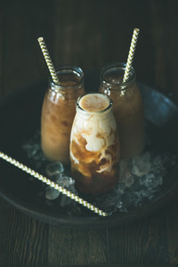 Cold Thai iced tea in glass bottles with milk