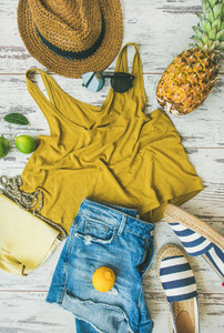 Colorful summer fashion outfit flat lay over pastel parquet background