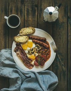 Traditional English breakfast with fried eggs  sausages  mushrooms  bacon