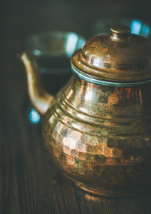 Oriental Middle Eastern tea pot and black tea in glasses