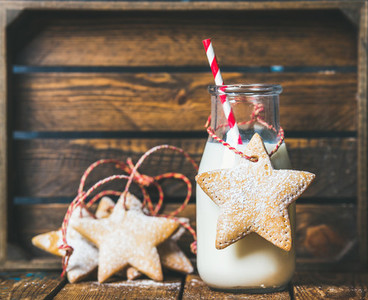 Christmas festive gingerbread star shaped cookies and bottle with milk