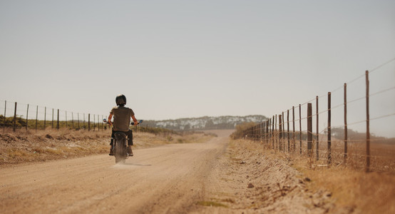 Man riding motor cycle on a country road