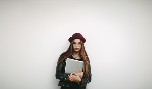 Portrait of a woman entrepreneur holding a laptop