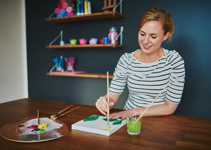 Creative female painting at desk